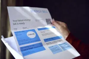 Close up of senior woman opening UK energy bill concerned energy direct debit
