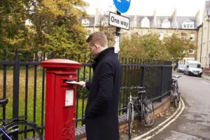 Man posting a letter in post box