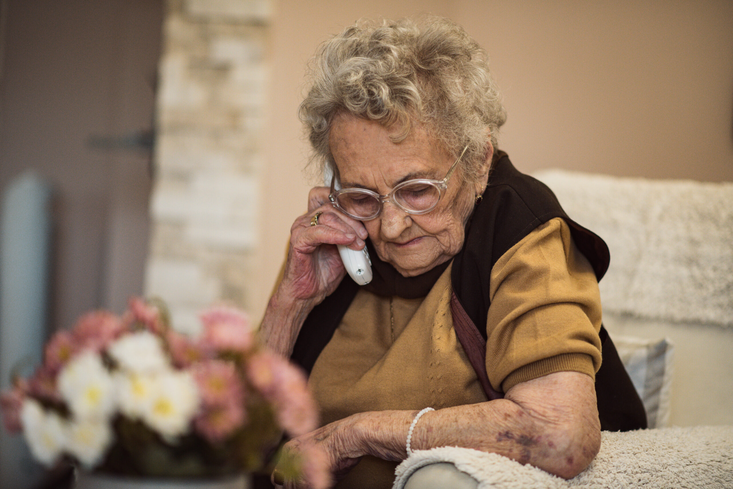 Older lady on a landline phone due BT compensation.